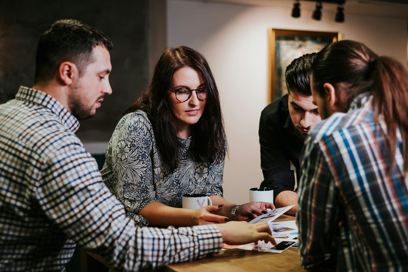 Four people reviewing documents at a table