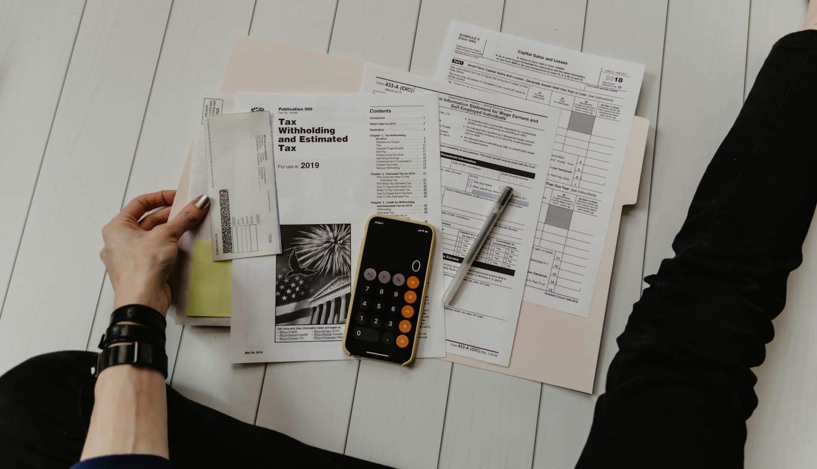 Calculator and paper schedules on a desk